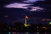 Vietnam, Hue, Flag at night across the Perfume River - John McDermott