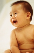 Baby boy (3 - 9 months old) laughing, looking away - Keith Brofsky