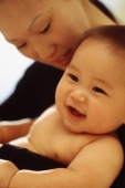 Mother looking at baby boy (3-9 months old) smiling - Keith Brofsky