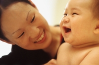 Mother looking at baby boy (3-9 months old) laughing - Keith Brofsky