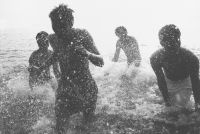 Teenagers splashing in the ocean, silhouette - Jade Lee