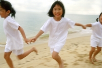Children in white outfits running along the beach - Alex Microstock02