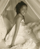 Woman in bed, smiling, portrait - Jack Hollingsworth