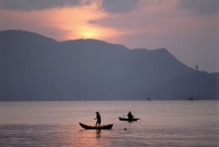 Vietnam, Quy Nho'n, boats in the South China Sea at sunset. - Steve Raymer
