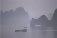 Vietnam, Halong Bay, boat in the mist. - Steve Raymer