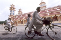 Vietnam, Tay Ninh, worshippers on bicycle outside Cao Dai Great Temple. - Steve Raymer