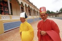 Vietnam, Tay Ninh, Cao Dai priests walking outside of Cao Dai Great Temple. - Steve Raymer