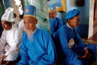 Vietnam, Tay Ninh, Cao Dai lay priests sitting in Cao Dai Great Temple. - Steve Raymer