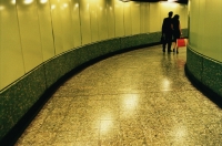 Hong Kong, man and woman walking in MTR (subway) station - Jade Lee