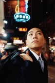 Hong Kong, man looking up, carrying briefcase over shoulder - Jade Lee