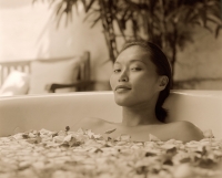 Woman in bathtub with flower petals - Jack Hollingsworth