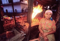 Indonesia, Sumatra, Aceh, Acehnese woman selling grilled meat at Sunset Beach. - Steve Raymer