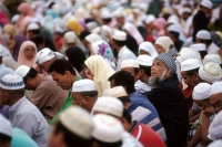 Malaysia, Kota Bahru, Muslims sit on dusty streets to listen to Pan -Malaysian Islamic Party speech. - Steve Raymer