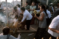 Cambodia, Phnom Penh, Cambodians make offerings at Buddhist temple. - Steve Raymer