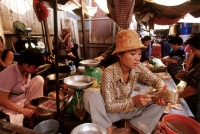 Cambodia, Phnom Penh, Cambodian woman counting money in market. - Steve Raymer