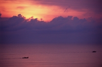 Malaysia, South China Sea, sunrise behind fishermen off of east coast. - Steve Raymer