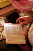 Malaysia, Muslim man reads from Koran. - Steve Raymer
