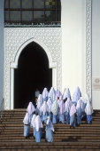 Malaysia, Kuala Lumpur, Muslim women wearing head scarves and prayer robes enter the National Islamic Center. - Steve Raymer