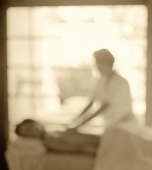 Woman getting a massage, window in background, defocused - Jack Hollingsworth