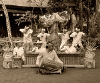 Indonesia, Bali, man playing hand drum, young boy dancers in traditional costume - Jack Hollingsworth