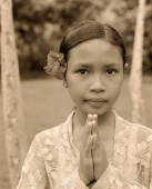 Indonesia, Bali, young girl with flower behind ear, traditional greeting, portrait - Jack Hollingsworth