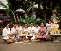 Indonesia, Bali, Balinese women and girls in traditional costume making floral arrangements - Jack Hollingsworth