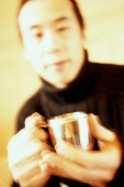Man holding silver cup. - Leila  Pivetta