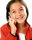 Young girl talking on cellular phone, white background. - Jade Lee