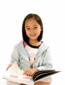 Young girl with book, white background. - Jade Lee