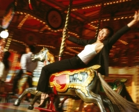 Woman riding horse on carousel. - Jack Hollingsworth