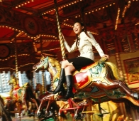 Woman riding horse on carousel. - Jack Hollingsworth
