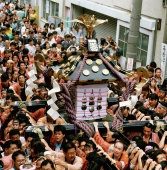 Japan, Tokyo, Portable shrine (mikoshi) is carried through the streets during Asakusa Matsuri (religious festival) - Rex Butcher