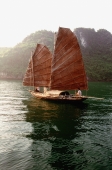 Vietnam, Halong Bay, Fishing junk sailing amongst the islands - Gareth Jones