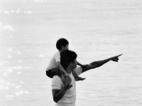 Father and son at beach, son on father's shoulders - Jade Lee