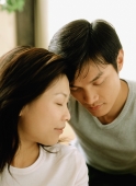 Couple with heads together, eyes closed - Jade Lee