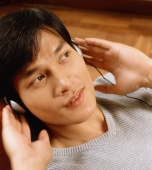 Man listening to headphones - Jade Lee