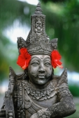 Indonesia, Bali, stone statue with flowers - Jill Gocher