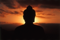 Indonesia, Java, Buddha figure at Borobudur temple at sunrise, silhouette - Jill Gocher