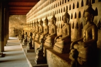 Laos, Vientiane, A row of stone Buddha statues in a hall of Wat Si Saket - Jill Gocher