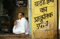 India, Man sitting in doorway - Jill Gocher
