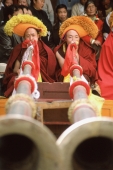 China, Szechuan (Sichuan), Kham region, Tibetan monks blowing horns. - Jill Gocher