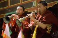 China, Szechuan (Sichuan), Kham region, Tibetan monks blowing horns. - Jill Gocher