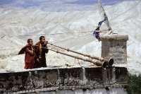 Nepal, Mustang, Lo Manthang, monks atop palace sounding horns. - Jill Gocher