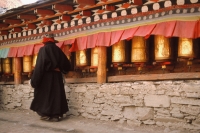 China, Szechuan (Sichuan), Kham region, Tibetan woman making kora ( pilgrimage) at monastery. - Jill Gocher