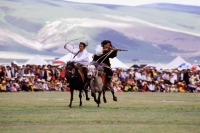 China, Szechuan (Sichuan), Kham region, Khampa horsemen show off their skills at the summer nomad festival. - Jill Gocher