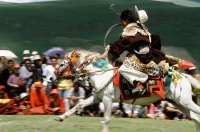 China, Szechuan (Sichuan), Kham region, A Khampa horseman show off his skills at the summer nomad festival. - Jill Gocher