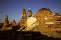 Thailand, Ayutthaya, Buddha in bright yellow robe. - James Marshall