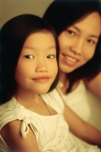 Young girl with mother in background, portrait - Marcus Mok