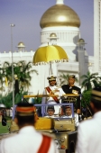 Brunei, Sultan Hassanal Bolkiah watches a military ceremony in honor of his birthday from a reviewing stand. - Steve Raymer