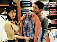 Woman helping man coordinate outfit at clothing store. - Jack Hollingsworth
